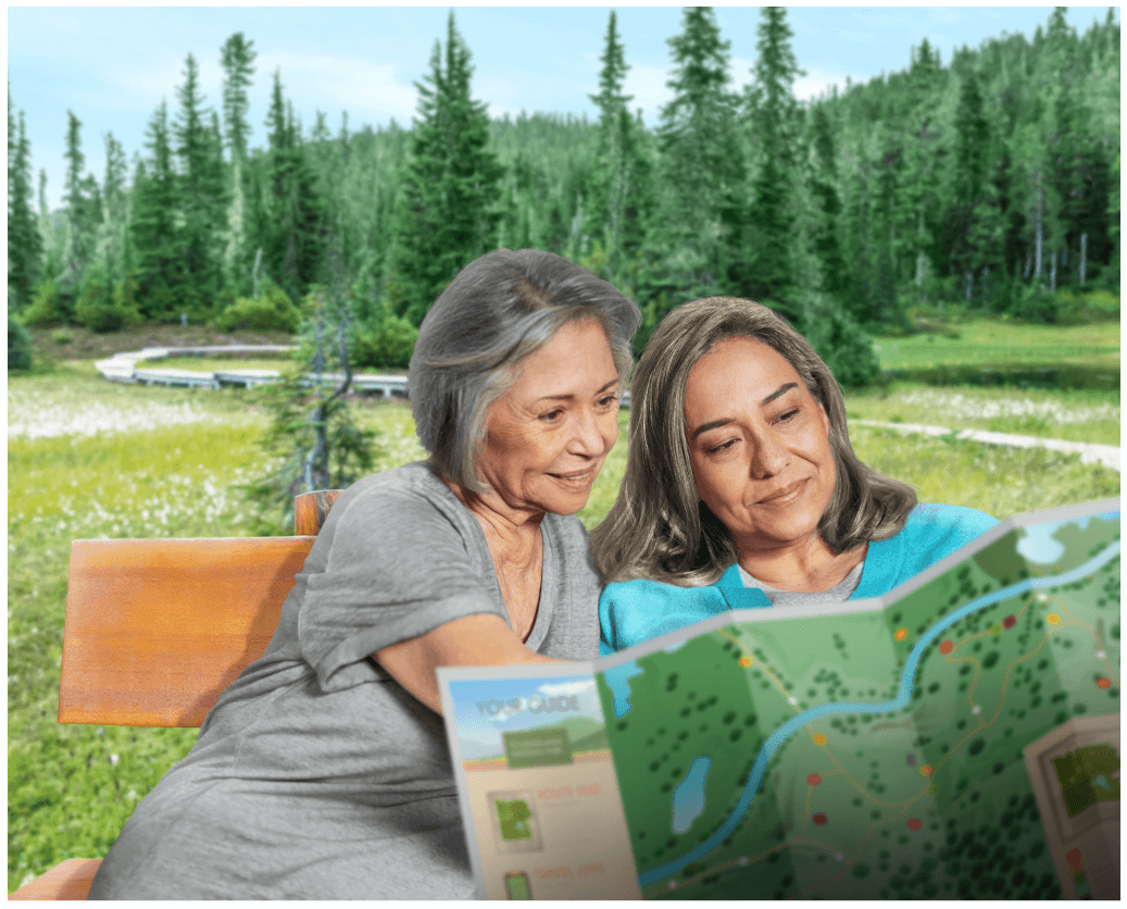 Two women reading a map while sitting on a park bench.